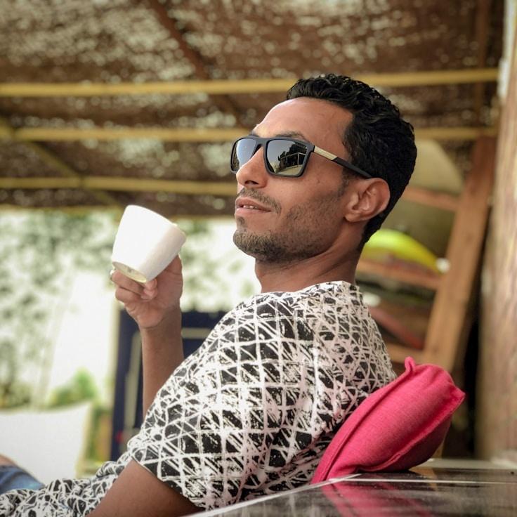 Alex Carter, Lead Design Curator at Quartz Pine Ridge, reviewing corporate floral arrangements